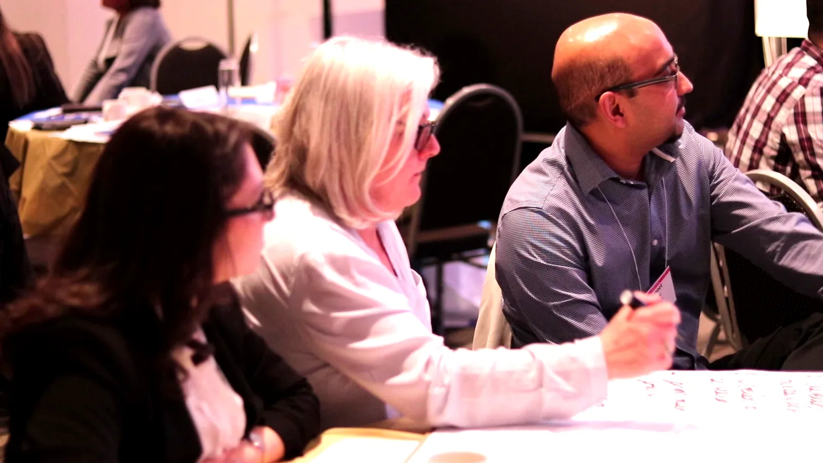 Two leaders in direct, open conversation — assertive without aggressive