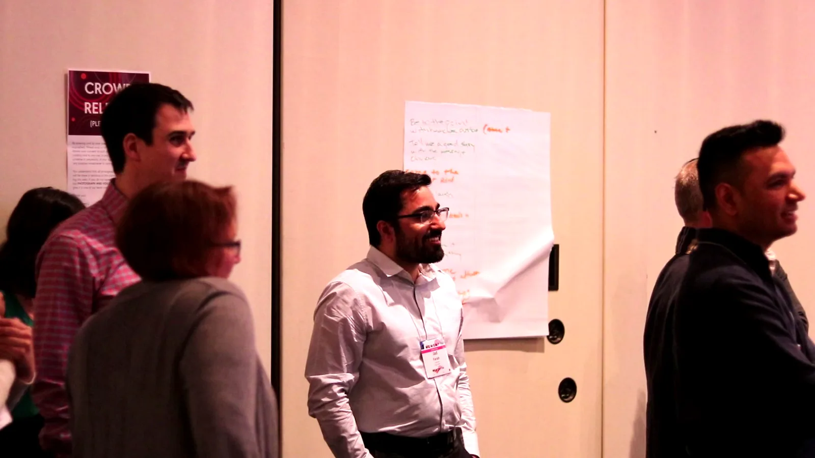 Team aligning around flipcharts during an immersive communication experience