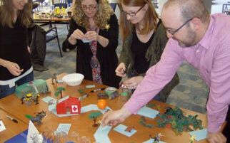 A group participating in teamwork exercises learned from Learn2