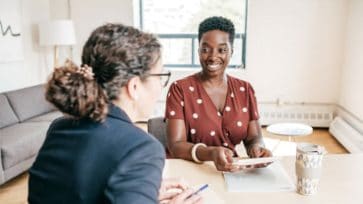 A leadership coach helping an employee